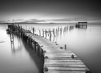 Moody photo of wooden bridge over a lake